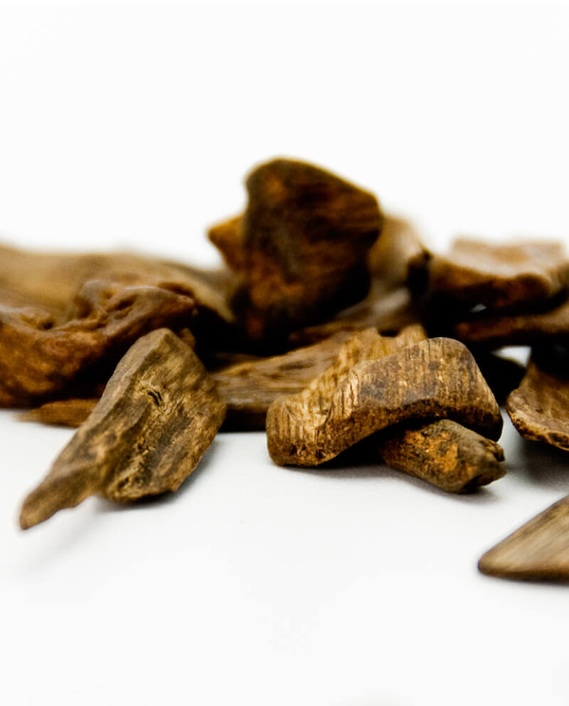 oud wood chips white background natural essential oil compoz